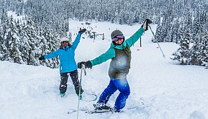 smiling skiers on nightmare trail