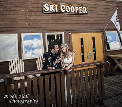 couple on lodge deck toasting with champaigne