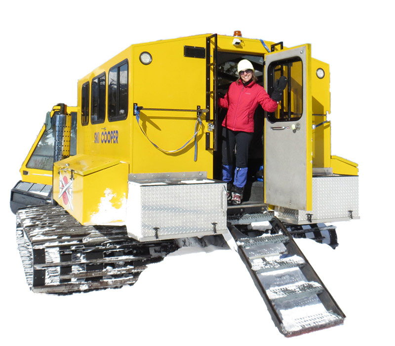 smiling skier exiting snowcat