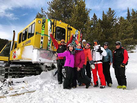 Smiling skiers behind a chicago ridge snowcat