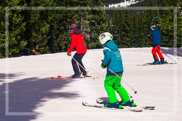 family skiing together