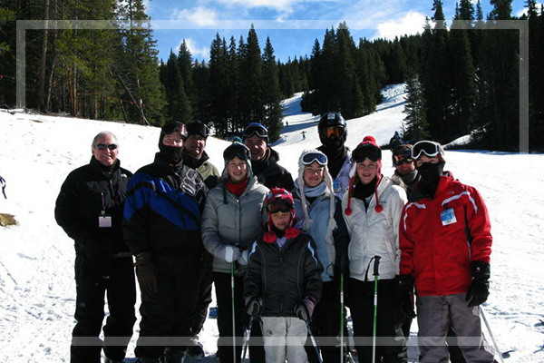 group of people posing at the base of the hill