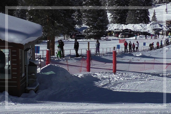 people riding the magic carpet up to the top of the beginner area