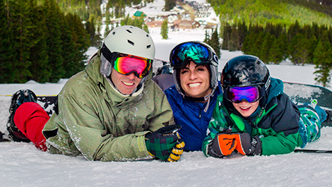 family of three on the top of the mountain