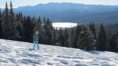 girl snowboarding in wide open spaces