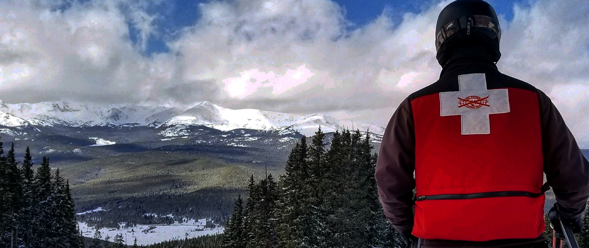 Ski Patroller looking at a view of the mountains