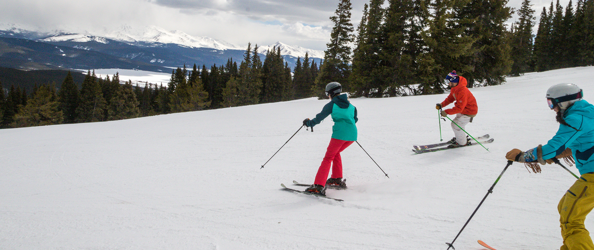 three skiers