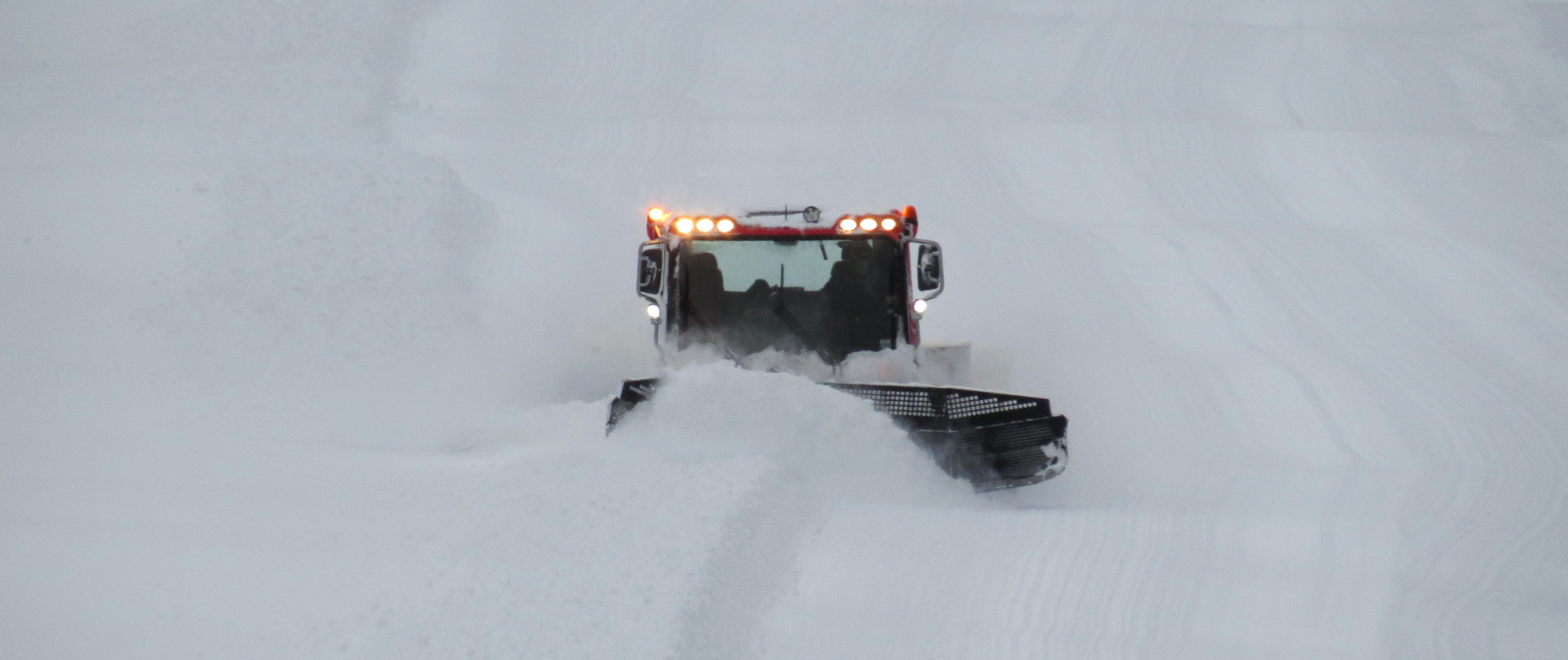 Groomer on a snowy slope