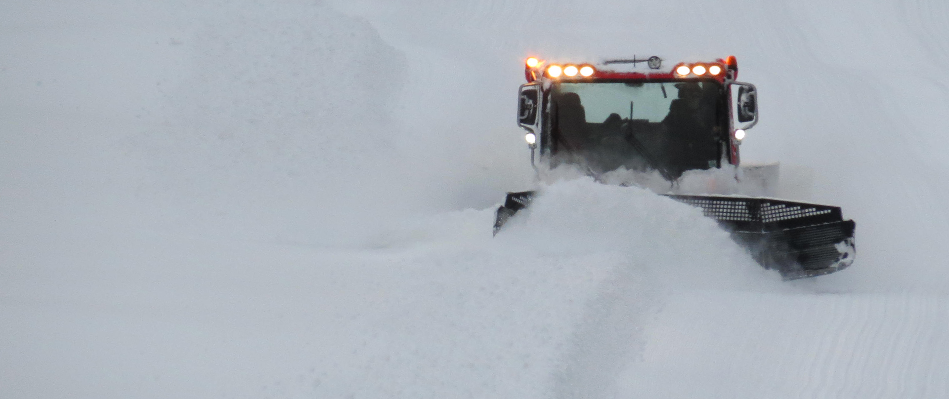 Groomer on a snowy slope